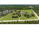 Gorgeous aerial view of the home and acreage with mature trees, open fields and long driveway at 1060 Still Rd, Pierson, FL 32180