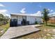 Charming cottage with a wooden deck, metal roof, and serene country setting at 1060 Still Rd, Pierson, FL 32180
