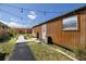 Cozy cottage exterior featuring string lights, wooden walkway, and natural landscaping at 1060 Still Rd, Pierson, FL 32180