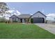 Charming one-story home with a lush green lawn and a two-car garage at 1060 Still Rd, Pierson, FL 32180