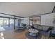 Comfortable indoor-outdoor living room with wood flooring and screened porch access at 1060 Still Rd, Pierson, FL 32180