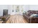 Comfortable living room with hardwood floors and modern media console with a brown couch at 1060 Still Rd, Pierson, FL 32180
