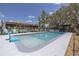 Large in-ground pool and patio area surrounded by lush landscaping and a black aluminum fence at 1060 Still Rd, Pierson, FL 32180