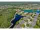 Panoramic aerial view of a residential community with houses nestled among trees and lakes at 1128 Hansberry Ct, Ormond Beach, FL 32174