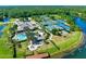 Aerial view of the community clubhouse featuring pool, tennis courts and lake at 1128 Hansberry Ct, Ormond Beach, FL 32174