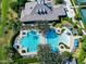 Aerial view of a resort-style community pool with chairs and palm trees at 1128 Hansberry Ct, Ormond Beach, FL 32174