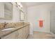 Bright bathroom features double sink vanity, granite countertops, and tiled backsplash at 1128 Hansberry Ct, Ormond Beach, FL 32174