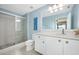 Well-lit bathroom featuring a tiled shower, a toilet, and a spacious vanity at 1128 Hansberry Ct, Ormond Beach, FL 32174