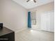 Minimalist bedroom with neutral walls, tile flooring, window, and closet at 1128 Hansberry Ct, Ormond Beach, FL 32174