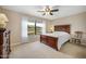Inviting bedroom featuring neutral walls, plush carpet, and large window view at 1128 Hansberry Ct, Ormond Beach, FL 32174