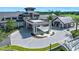 Stately clubhouse featuring a covered portico, stone accents, and meticulously landscaped entrance with golf cart at 1128 Hansberry Ct, Ormond Beach, FL 32174