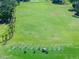 Expansive driving range featuring well-maintained greens and clear markers, framed by mature trees at 1128 Hansberry Ct, Ormond Beach, FL 32174
