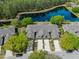 Aerial view of townhomes with well-manicured lawns and landscaping along a tranquil lake at 1128 Hansberry Ct, Ormond Beach, FL 32174