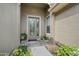 Inviting front entrance featuring decorative glass door, sidelight, and attractive landscaping at 1128 Hansberry Ct, Ormond Beach, FL 32174