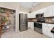 Kitchen with stainless steel appliances, white cabinets, and large pantry at 1128 Hansberry Ct, Ormond Beach, FL 32174