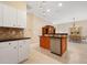 Kitchen with stainless steel dishwasher, dark countertop island and tile floors at 1128 Hansberry Ct, Ormond Beach, FL 32174
