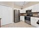 Kitchen with stainless steel appliances, white cabinets, and a pantry area at 1128 Hansberry Ct, Ormond Beach, FL 32174