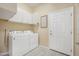 Laundry room with washer, dryer, cabinets, and door at 1128 Hansberry Ct, Ormond Beach, FL 32174