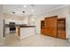Open-concept living area features an updated kitchen and hardwood cabinets at 1128 Hansberry Ct, Ormond Beach, FL 32174