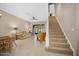 Bright living room with tile floors, a staircase, and access to the screened porch at 1128 Hansberry Ct, Ormond Beach, FL 32174