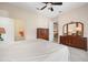 Bright main bedroom with ceiling fan, neutral walls, and dresser at 1128 Hansberry Ct, Ormond Beach, FL 32174