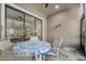 Cozy screened porch with outdoor seating, ceiling fan, and a view of the surrounding nature at 1128 Hansberry Ct, Ormond Beach, FL 32174