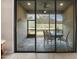 Relaxing screened in porch with outdoor seating and view of the surrounding nature at 1128 Hansberry Ct, Ormond Beach, FL 32174