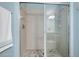 Tiled shower with glass door and stone flooring, providing a modern spa-like experience at 1128 Hansberry Ct, Ormond Beach, FL 32174