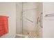 Shower stall features clear glass doors, tile surround, grab bars, and mosaic tile floor at 1128 Hansberry Ct, Ormond Beach, FL 32174