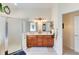 Bathroom featuring a double vanity, walk-in shower, and a door to the toilet room at 1404 Newry Cir, Ormond Beach, FL 32174