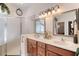 Bathroom with a double vanity, framed mirrors, walk-in shower, and modern fixtures at 1404 Newry Cir, Ormond Beach, FL 32174