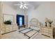 Bright bedroom with matching vanities, large mirror, and a window with blue curtains at 1404 Newry Cir, Ormond Beach, FL 32174