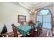 Formal dining room with chandelier, window, and spacious seating for eight guests at 1404 Newry Cir, Ormond Beach, FL 32174