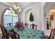 Dining room boasting a large bay window, chandelier, and seating for ten at 1404 Newry Cir, Ormond Beach, FL 32174