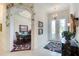 Elegant foyer with tile flooring, decorative rug, and glass paneled double doors at 1404 Newry Cir, Ormond Beach, FL 32174