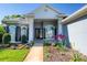 Inviting home entrance with manicured landscaping, a decorative door, and elegant architectural details at 1404 Newry Cir, Ormond Beach, FL 32174