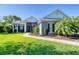 Charming home featuring a lush green lawn and mature landscaping for enhanced curb appeal at 1404 Newry Cir, Ormond Beach, FL 32174