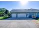 Spacious three-car garage with ample parking space and a well-maintained exterior at 1404 Newry Cir, Ormond Beach, FL 32174