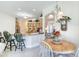 Inviting eat-in kitchen connected to dining area, featuring a breakfast bar and plenty of light at 1404 Newry Cir, Ormond Beach, FL 32174