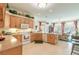 Well-lit kitchen featuring bright wooden cabinetry, tile flooring, and an open layout at 1404 Newry Cir, Ormond Beach, FL 32174