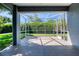 A covered lanai with tile flooring and views of the backyard, perfect for outdoor entertaining at 1404 Newry Cir, Ormond Beach, FL 32174