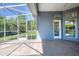 The screened-in lanai features tile flooring and views of the backyard at 1404 Newry Cir, Ormond Beach, FL 32174