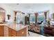 Open floor plan showcasing the kitchen connected to the living room with abundant natural light at 1404 Newry Cir, Ormond Beach, FL 32174