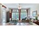 Bright living room with large windows, a ceiling fan, and comfortable seating arrangements at 1404 Newry Cir, Ormond Beach, FL 32174