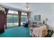 Spacious living room with large windows, comfortable seating, and bright natural light at 1404 Newry Cir, Ormond Beach, FL 32174
