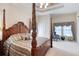 Bedroom featuring a four-poster bed, tray ceiling, and ample natural light at 1404 Newry Cir, Ormond Beach, FL 32174