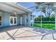 A covered patio with a ceiling fan and tile flooring is ideal for outdoor enjoyment at 1404 Newry Cir, Ormond Beach, FL 32174