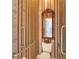 Stylish powder room with an ornate mirror, grab bars, and decorative wallpaper at 1404 Newry Cir, Ormond Beach, FL 32174