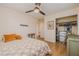Cozy bedroom featuring hardwood floors, ceiling fan, and quilt-patterned bedspread at 151 Holland Rd, Ormond Beach, FL 32176