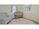 Charming Bedroom featuring a rocking chair, crib, and built-in shelving at 151 Holland Rd, Ormond Beach, FL 32176